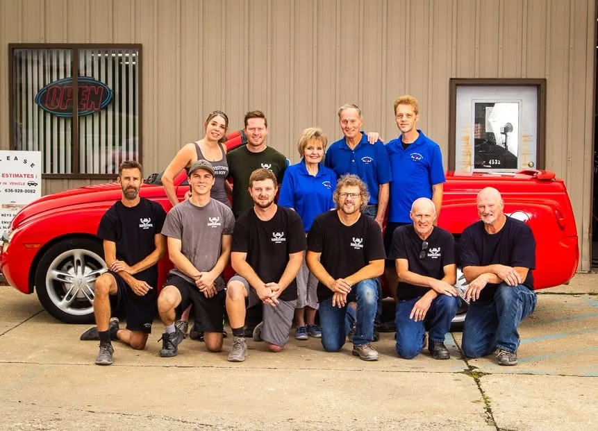 Harvestowne Auto Body team members and family gathered in front of the shop in Saint Peters, MO